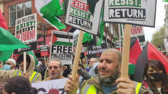 Pro-Palestine protesters holding placards with messages such as, "Free Palestine; end Israeli occupation."