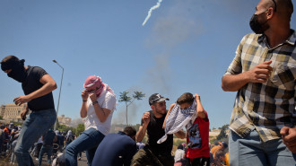 Palestinians Israeli tear gas / Qassam Muadddi