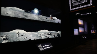 A picture taken on June 3, 2019, shows images of astronauts on the moon exhibited inside the Clock Tower Museum in the Saudi holy city of Mecca. - Overlooking the Kaaba, a black structure inside the Grand Mosque towards which Muslims around the world turn to pray, the four-storey Clock Tower Museum, opened a month ago. It is filled with models and structures on astronomy and galaxies, as Saudi authorities aim to lure more Muslim tourists to the country