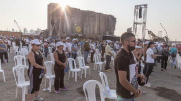 Families of victims of the Beirut Port explosion observe a minute silence during an anniversary commemoration on August 4, 2021 in Beirut, Lebanon [Getty Images]