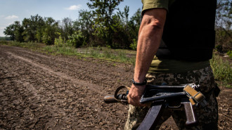 A Ukrainian soldier with a rifle in his left hand