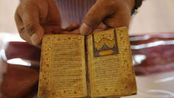 A man looks during an extraordinary five-day exhibition of rare Islamic art work, Quranic manuscripts, Islamic art objects and calligraphy specimen