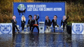 limate change activists dressed as world leaders, including from left, Japan's Prime Minister Fumio Kishida, Saudi Arabia's King Salman bin Abdulaziz, Canada's Prime Minister Justin Trudeau, Britain's Prime Minister Boris Johnson, Australia's Prime Minister Scott Morrison, Brazil's President Jair Bolsonaro, and US President Joe Biden, pose for a photograph during a demonstration in the Forth and Clyde Canal in Glasgow 