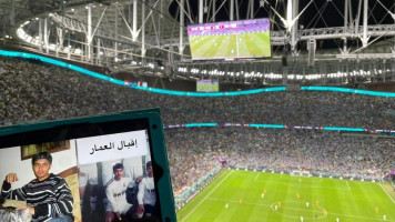 A picture of Iqbal, a Syrian detainee, is held up in front of a World Cup match in Doha. [Provided with permission by Families for Freedom].