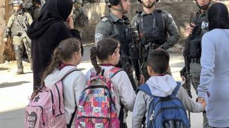 Palestinian children and teachers trying to navigate inside the refugee camp as the Israeli army demolished the Tamimi home, 25 January 2023. [Ibrahim Husseini/TNA]