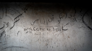 Welcome to hell, written with charcoal on the wall of a refugee squat. Refugees are mainly from Afghanistan and North  Africa. January 2023. 