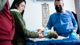  Dr. Aso Faeq Salih examines a one year-old boy affected by multiple birth defects, including a heart condition. (Abigail Bobo)