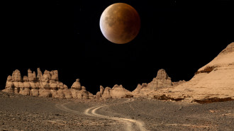 Composite image of the blood moon created by the lunar eclipse and the Acacus mountains in the Libyan desert.