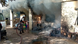 Fire fighters work to extinguish a blaze in the Dhayrah mayor's home, caused by Israeli strikes on Tuesday morning. [Shared by TNA with permission]