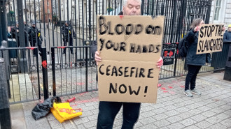 Man holds placard outside Downing Street 