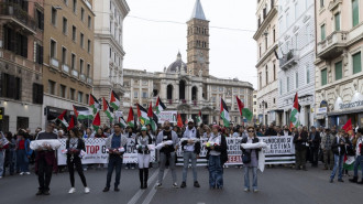 Protesters hold mock dead bodies and Palestinian flags during a demonstration in support of the Palestinian people in Rome, Italy on 30 March 2024