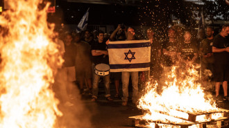 The protesters lit fires outside the Ministry of Defence building in Tel Aviv [Getty]