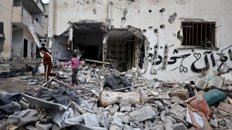  Children walk amid the rubble of a building destroyed during an Israeli raid at the Nur Shams camp for Palestinian refugees near the occupied West Bank city