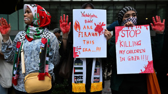 Protesters hold placards during a demonstration to support Palestinians during the American independence day dinner organized by the US embassy in Malaysia at the Mandarin Oriental Hotel in Kuala Lumpur on June 10, 2024.