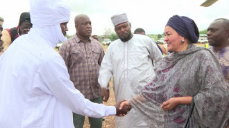 This video grab taken from an AFPTV video shows the Uited Nations deputy secretary-general Amina Mohammed (R) greeting a local official as she arrives in Adre on August 30, 2024. The UN's deputy secretary-general Amina Mohammed welcomed food aid reaching Sudan but said it is insufficient as she visited a border post in Chad to witness the passage of a humanitarian convoy. During her visit to the Adre border crossing, she also called for a resolution to the fighting in Sudan.