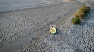 A boat lays on the ground of a dried out lake in the village of Comana, Romania, on September 7, 2024. Southern and eastern Europe are facing "persistent and recurrent drought conditions," according to the latest situation report by the European Union.