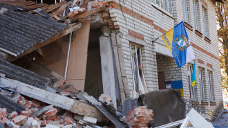  A flag with the coat of arms of the Kursk region is placed on a damaged building on September 10, 2024 in Sudzha, Kursk Region, Russia. 