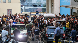 Ambulances are surrounded by people at the entrance of the AUB Medical Center, on September 17, 2024, after explosions hit locations in several Hezbollah strongholds around Lebanon amid ongoing cross-border fighting with Israel (Photo by Anwar AMRO)