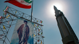 A big banner depicting Iran's Supreme Leader Ayatollah Ali Khamenei is placed next to a ballistic missile in Baharestan Square in Tehran, Iran, on September 26, 2024