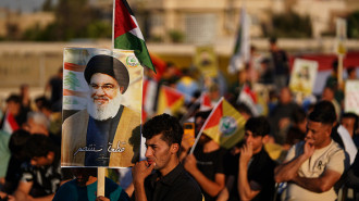 Supporter of Kataeb Sayyid al-Shuhada armed faction (member of the Hashed al-Shaabi / Popular Mobilisation Forces or PMF) hold a portrait of Hezbollah chief Hassan Nasrallah during a solidarity stand against the Israeli aggression on Lebanon and Palestine near the Great Mosque of Mosul.