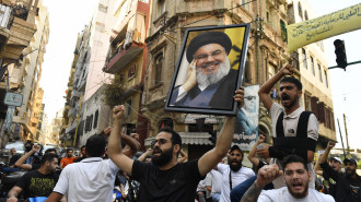 A group gather carrying Nasrallah's poster and chanting slogans following Hezbollah's statement after Hezbollah Secretary General Hassan Nasrallah was killed 