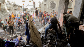 Palestinians gather amidst the rubble following an Israeli airstrike near the Jabalia Services Club in the northern Gaza Strip on October 5, 2024. 