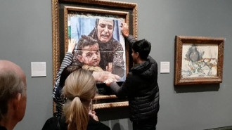 Youth Demand activists cover the Picasso painting 'Motherhood' with a photo of a Gazan mother and child to call for a mutual arms embargo on Israel at the National Gallery in London on October 09, 2024. (Youth Demand/Anadolu Agency via Getty Images)