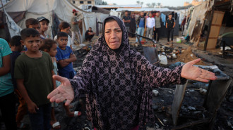 Palestinian woman observes the site of an Israeli strike on tents sheltering displaced people at Al-Aqsa Martyrs hospital in Deir Al-Balah, central Gaza Strip, October 14, 2024. (Photo by Majdi Fathi/NurPhoto via Getty Images)