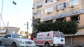 An ambulance arrives at the site of an overnight Israeli airstrike that targeted a branch of the Al-Qard Al-Hassan finance group in the southern city of Tyre on October 21, 2024. (Photo by BILAL KASHMAR/AFP via Getty Images)