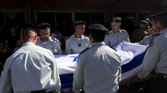 Israeli soldiers carry a coffin covered with Israeli flag during a funeral for Warrant Officer (res.) Guy Idan, 51, on October 25, 2024 in Shomrat, Israel. (Photo by Amir Levy/Getty Images)