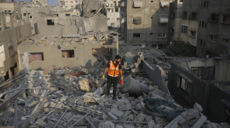 Civil defense teams conduct a search and rescue operation in the area following Israeli army attacked on Nuseirat Refugee Camp in Gaza City