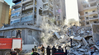 Rescuers and civilians check the site of an Israeli strike on a building in Beirut's southern Ghobeiri neighbourhood, on November 15, 2024, amid the ongoing war between Israel and Hezbollah. (Photo by FADEL ITANI/AFP via Getty Images)