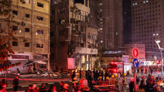 Israeli security services stand in front of a heavily damaged building at the site of a rocket attack from southern Lebanon in Ramat Gan, north of Tel Aviv, on November 18, 2024, amid the ongoing war between Israel and Hezbollah. (Photo by Jack GUEZ)