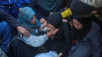 Relatives of the Palestinians who died as a result of Israeli attack on Nuseirat Refugee Camp mourn as dead bodies were taken from the al-Aqsa Martyrs Hospital for burial in Deir al-Balah, Gaza on November 21, 2024.