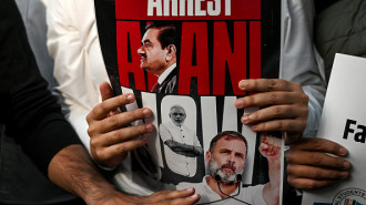 National Students' Union of India (NSUI) activists hold placards as they shout slogans during a protest demanding the arrest of Indian tycoon Gautam Adani over corruption allegations by US prosecutors, in New Delhi on November 21, 2024.