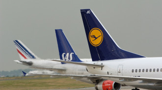 Tails of a Lufthansa DLH, Germany Boeing 737-530 and SAS Boeing 737 with AirFrance Boeing 747 taxiing behind.