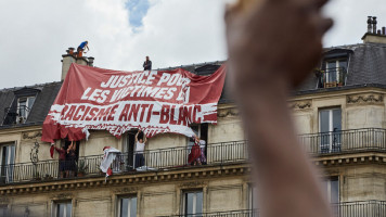 Generation Identitaire displays a racist banner [GETTY]