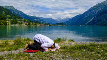 Muslim man praying in Switzerland - Lightrocket