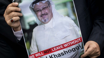 A man attends rally carrying Khashoggi poster