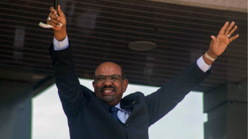 Sudan's President Omar al-Bashir gestures during