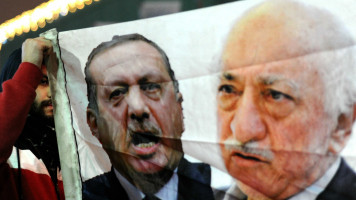 Protester holds banner of Erdogan and Gulen