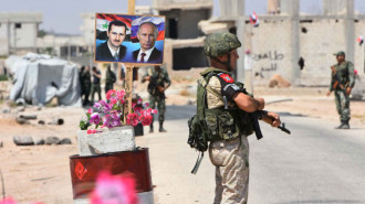 Assad Putin posters Idlib - AFP