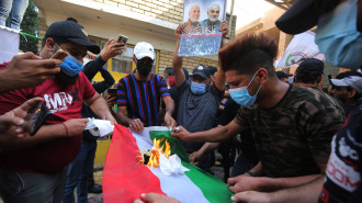 PMF protesters Kurdish flag - Getty