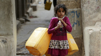 Yemeni girl with jerrycans