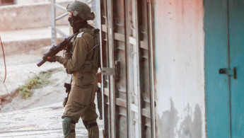 An Israeli soldier holding a gun