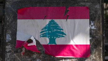 Lebanon flag poster teared on a wall, Beirut Governorate, Beirut, Le