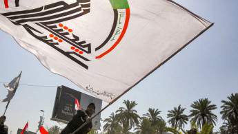 Members of Iraq's PMF march in a symbolic funerary parade in Baghdad on 29 June, 2021, in remembrance of those killed in a recent US raid. [Getty]