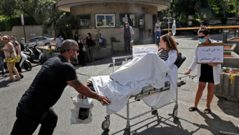 Healthworkers in north Lebanon protested, holding up signs saying "No electricity = No hospital" [Getty]