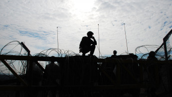 Several Israeli soldiers near a barbed-wire barrier