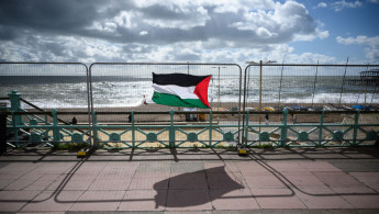 A Palestinian flag blows in the strong winds on the Brighton sea front [Getty Images]